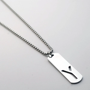 Detail view of rectangular military tag pendant with hollow letter Y on ball chain