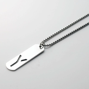 Detailed view of silver titanium steel rectangle pendant with hollow letter Y carving