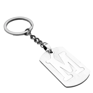 Stainless steel keychain with hollow letter M pendant and polished silver finish on white background