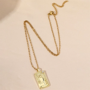 Vintage gold tarot card pendant necklace featuring The Magician with cubic zirconia stone
