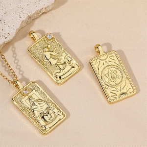 Detail of tarot card pendants with gold plating, embossed patterns and zircon stone