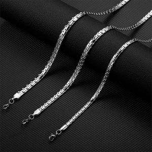 Polished silver stainless steel box chain necklace with lobster clasp in a 3-layer layout