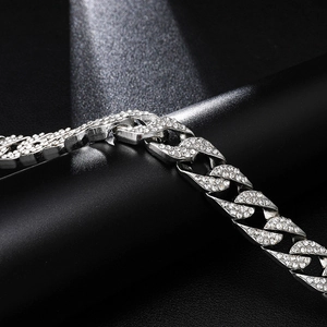 Macro side view of silver Cuban link chain with dense sparkling rhinestones