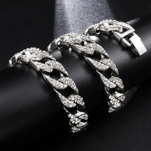 Close-up of hip-hop silver Cuban link bracelet with full crystal pavé on black stand