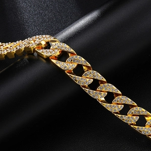 Detailed close-up of 18k gold plated Cuban chain bracelet with iced out micro pavé crystals