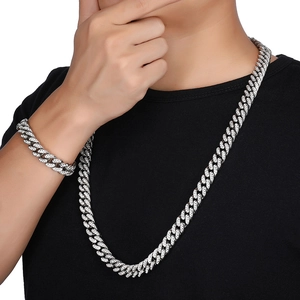 Detail of silver plated iced out Cuban link chain set with sparkling rhinestones for men