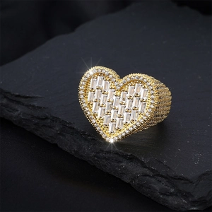 Macro shot of hip hop heart ring featuring gold plating and iced out cubic zirconia stones