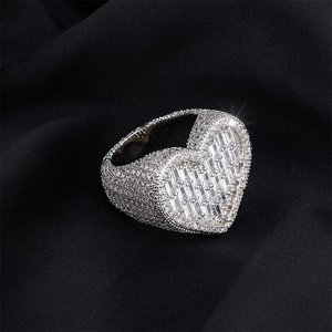 Macro shot of silver heart ring featuring pavé diamonds and step-cut baguette zircons