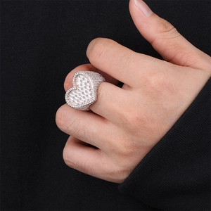 Close-up of iced out heart ring with cubic zirconia stones on model hand