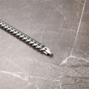 Close-up of silver Cuban link chain bracelet with a secure flat rectangular clasp