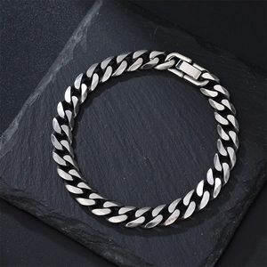 Detailed view of silver Cuban link chain bracelet with a heavy-duty folding clasp on stone