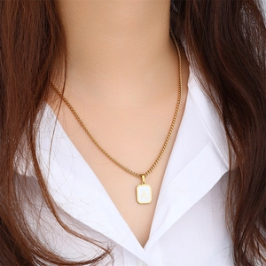 Square gold stainless steel necklace with white shell pendant featuring letter A design