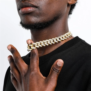 Close-up of hip hop cuban link chain with zircon stones on male model with black t-shirt