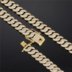 Detail van gouden hiphop Cubaanse schakelketting met dubbele rij diamanten en luxe boxsluiting