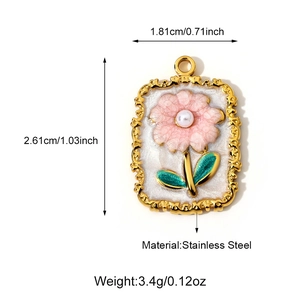 Macro view of a gold-plated stainless steel floral pendant with pearl and white enamel