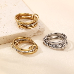 Interlocked stainless steel stacking ring set with zircon pavé in gold and silver finish