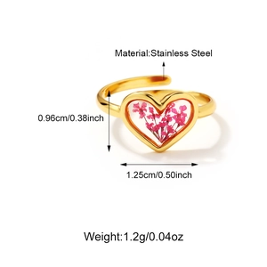 Detailed macro view of 18K gold stainless steel heart ring with purple dried flower resin
