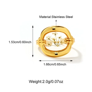 Detailed macro view of 18K gold stainless steel ring with white dried flower centerpiece