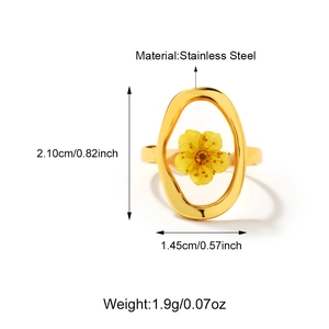 Detail view of 18K gold stainless steel ring featuring yellow dried flower inlay