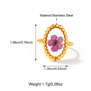 Detail of 18K gold stainless steel ring with purple dried flowers and beaded texture