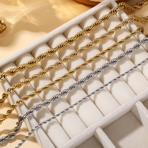 Various sizes of gold and silver stainless steel rope chains on jewelry tray