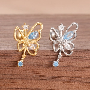 Exquisite butterfly earrings with blue cubic zirconia stones on dark wood background