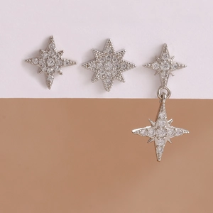 Detailed view of silver star earrings with sparkling cubic zirconia on split background