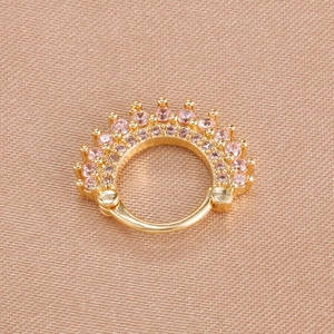 Detailed close-up of golden crown hinged hoop earring with shiny pink zircon stones