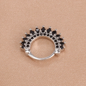 Detail of a hinged hoop ring with double rows of pavé-set black crystals on pink silk