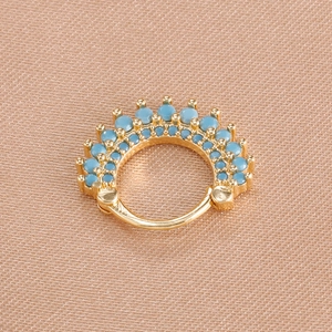 Elegant gold piercing hoop ring with turquoise beads and ball closure on silk background
