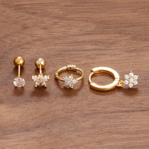 Detailed macro view of S925 engraved hallmark on golden flower earrings with zircon