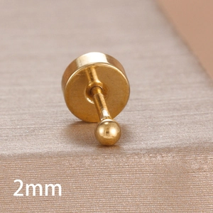 Macro shot of a 2mm gold-plated solid ball stud earring with flat back piercing base