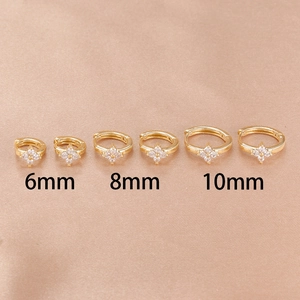 Three gold clover huggie hoop earrings with white zircon in 6mm, 8mm, and 10mm sizes