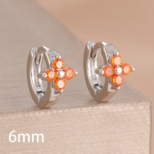 Close-up of 6mm silver hoop earring with orange zircon four-leaf clover design