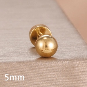 Macro view of a 5mm gold ball stud earring with polished metallic finish and smooth texture