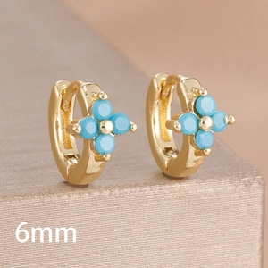 Close-up of 6mm golden clover earrings featuring bright sky blue beads and polished finish