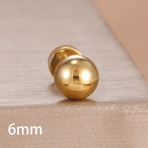 Macro detail of a 6mm golden ball stud earring with mirror polished surface finish