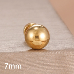 Macro shot of 7mm minimalist gold-plated ball stud earring with mirror finish surface