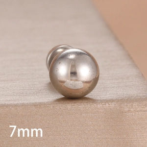 Macro shot of a 7mm polished silver ball earring with high-shine mirror finish surface