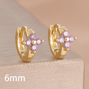 Macro shot of 6mm gold-plated hoop earrings with purple zircon flower clover charm