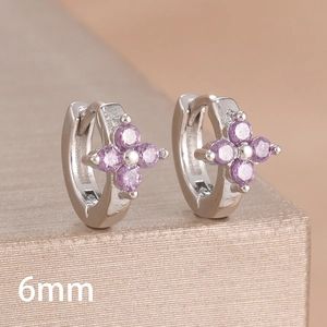 Macro view of 6mm silver hoop earrings featuring four purple cubic zirconia stones