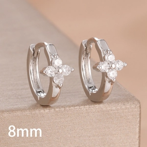 Macro detail of 8mm silver clover earrings with sparkling cubic zirconia inlay