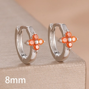 Detail of 8mm silver clover earrings with sparkling orange cubic zirconia stones