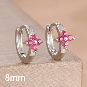 Macro shot of silver clover hoop earrings with pink gemstones in 8mm inner diameter