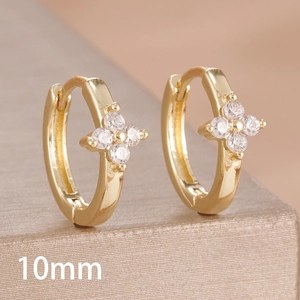 Detail shot of 10mm gold hoop earrings with four-leaf clover zircon inlay and hinge clasp
