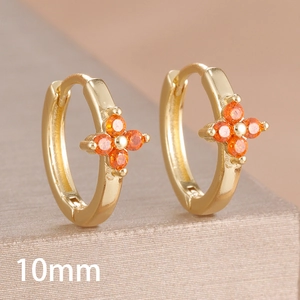 Detailed close-up of 10mm golden hoop earring with orange zircon four-leaf clover design