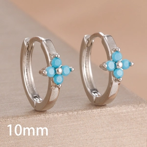 Macro view of 10mm silver clover hoop earrings featuring bright blue turquoise beads