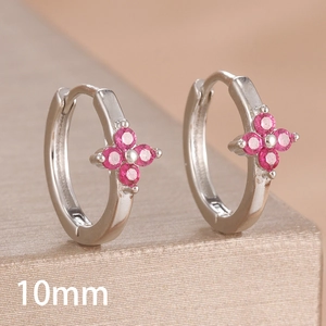 Macro shot of 10mm silver hoop earring featuring a pink zircon four-leaf clover detail