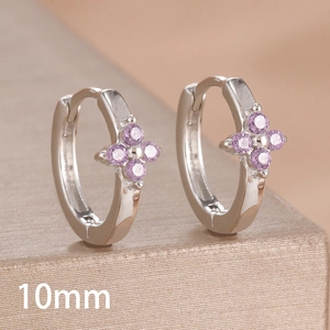 Macro view of 10mm silver clover hoop earrings featuring round purple zircon stones