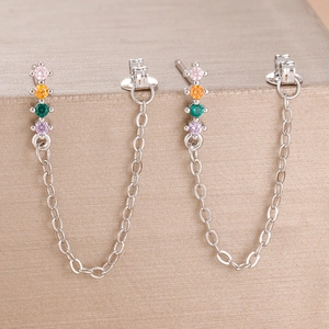 Detailed close-up of S925 silver stud earrings with colorful zircon stones and fine chain